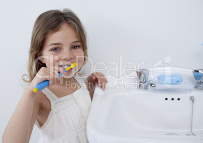 Portrait of a little girl cleaning her teeth