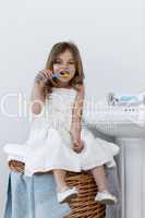 Daughter cleaning her teeth in bathroom