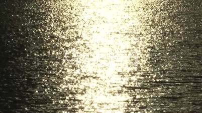 Gold sun reflection on water surface
