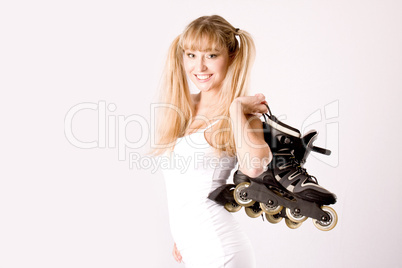 young girl with roller skates on the shoulder