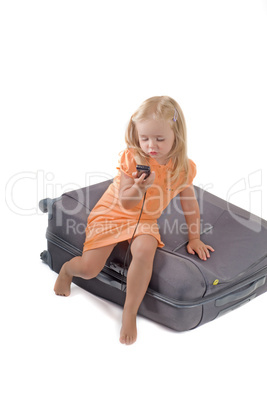Little girl and suitcase in studio