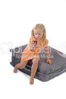 Little girl and suitcase in studio