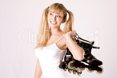 young girl with roller skates on the shoulder