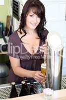 young brunette draws beer at the bar