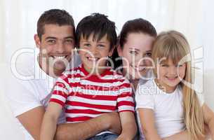 Portrait of family sitting on sofa together