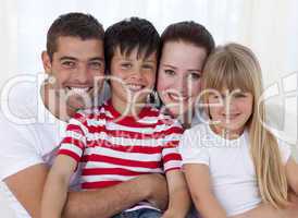 Portrait of smiling family sitting on sofa together