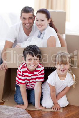 Family moving house playing with boxes