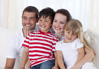 Happy family sitting on sofa together