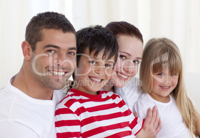 Portrait of parents, daughter and son sitting on sofa together