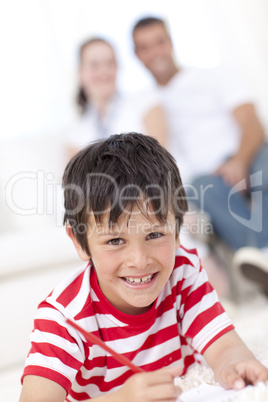 Smiling kid painting on floor in living-room
