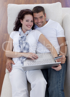 Family shopping online with laptop and credit card
