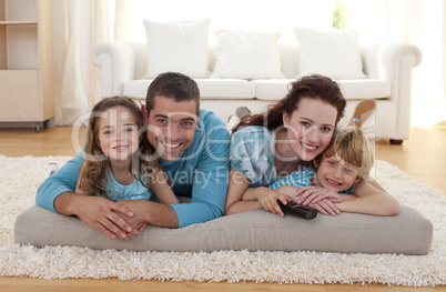Smiling family on floor in living-room