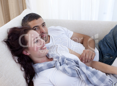 Couple lying on sofa