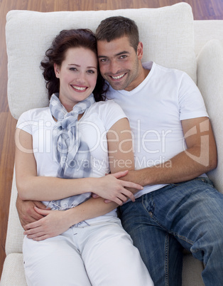 High angle of couple lying on sofa