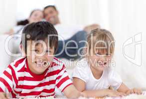 Brother and sister lying on floor in living-room