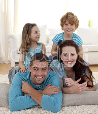 Parents, daughter and son on floor in living-room