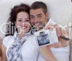Portrait of couple playing with digital camera