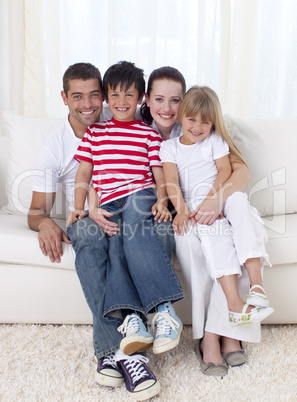 Family sitting on sofa together