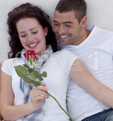 Couple on sofa with a rose