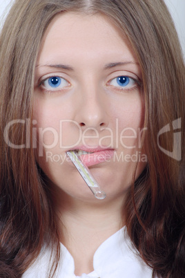 The nice girl holding in a mouth a thermometer