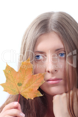 The thoughtful girl with maple autumn sheet