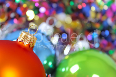 New Year's fur-tree toys against a multi-coloured tinsel