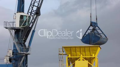 Crane unloading cargo ship in harbor