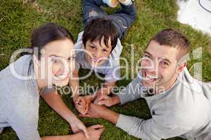 Parents and kid lying on garden