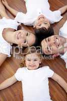 Family lying on floor with heads together