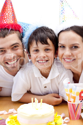 Smiling family celebrating son's birthday