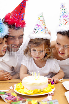 Little girl celebrating her birthday with her parents