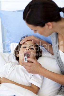Close-up of mother taking her son's temperature with a thermomet