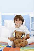 Happy kid playing with headphones and teddy bear