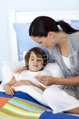 Mother taking her son's temperature