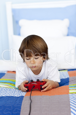 Boy playing videogames in his bedroom