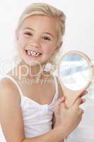 Little girl playing holding a mirror