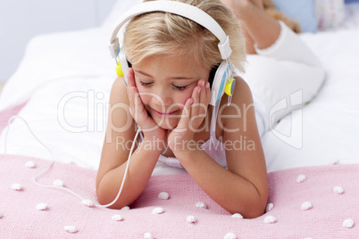 Little girl in bed listening to the music