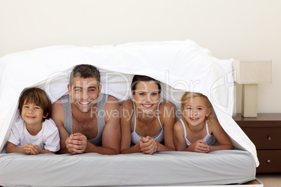 Happy family under the sheets