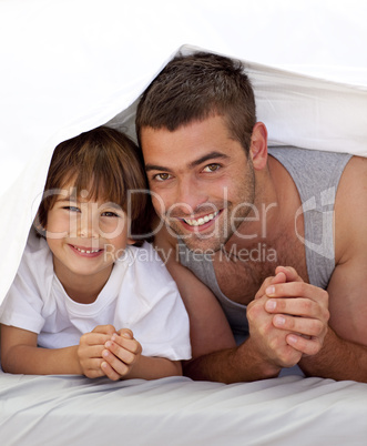 Father and son together under the bedsheets