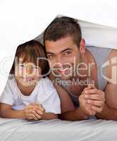 Father and son together under the bedsheets