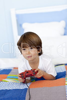 Boy in his bed playing videogames