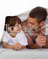 Father and son talking under the bedsheets