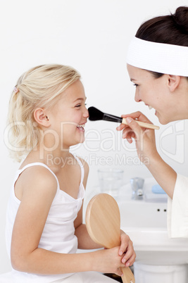 Daughter and mother putting makeup