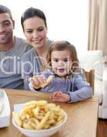 Little girl eating fries at home