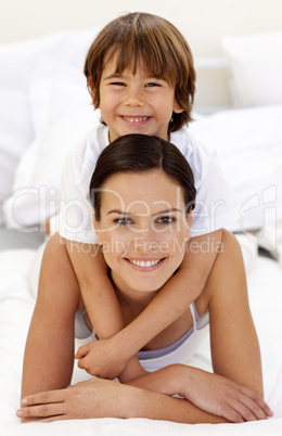 Son hugging his mother in bed
