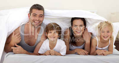 Parents and children playing in parent's bed