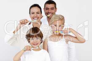 Family cleaning their teeth in bathroom