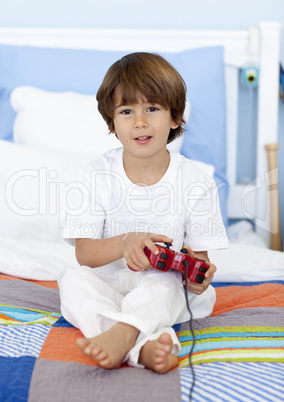 Boy sitting in bed playing videogames