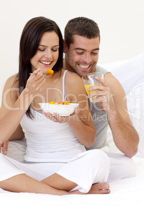 Couple having nutritive breakfast in bed