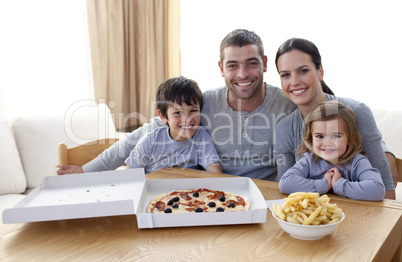 Family eating pizza and fries at home